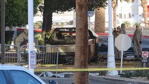 Investigators photograph a Tesla Cybertruck that exploded outside the lobby of President-elect Donald Trump's hotel on January 1, 2025, in Las Vegas. At least one person was killed and seven wounded when a Tesla Cybertruck exploded outside a hotel belonging to US President-elect Donald Trump in Las Vegas, police said Wednesday. (Photo by WADE VANDERVORT / AFP) (Photo by WADE VANDERVORT/AFP via Getty Images)