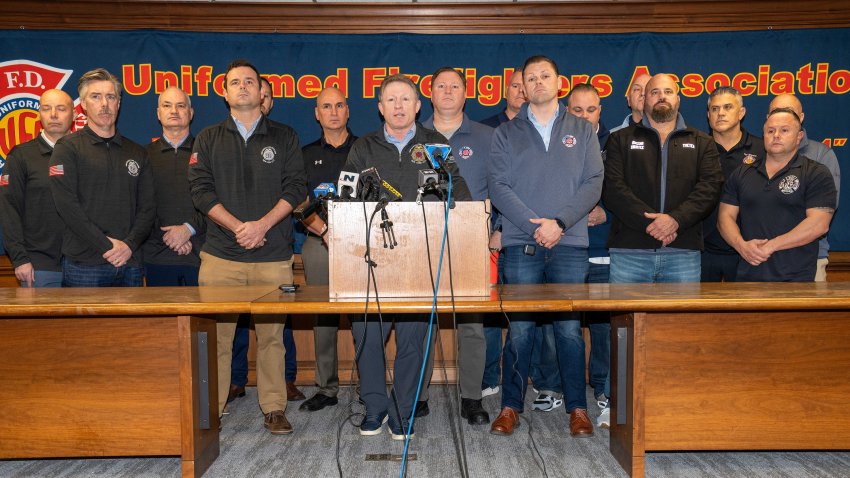 James Brosi (center), president of the Uniformed Fire Officers Association, is joined by Andrew Ansbro, president of the Uniformed Firefighters Association, and firefighters at a press conference Sunday, Jan. 5, 2025, to publicize concerns about congestion pricing. (Theodore Parisienne/New York Daily News/Tribune News Service via Getty Images)