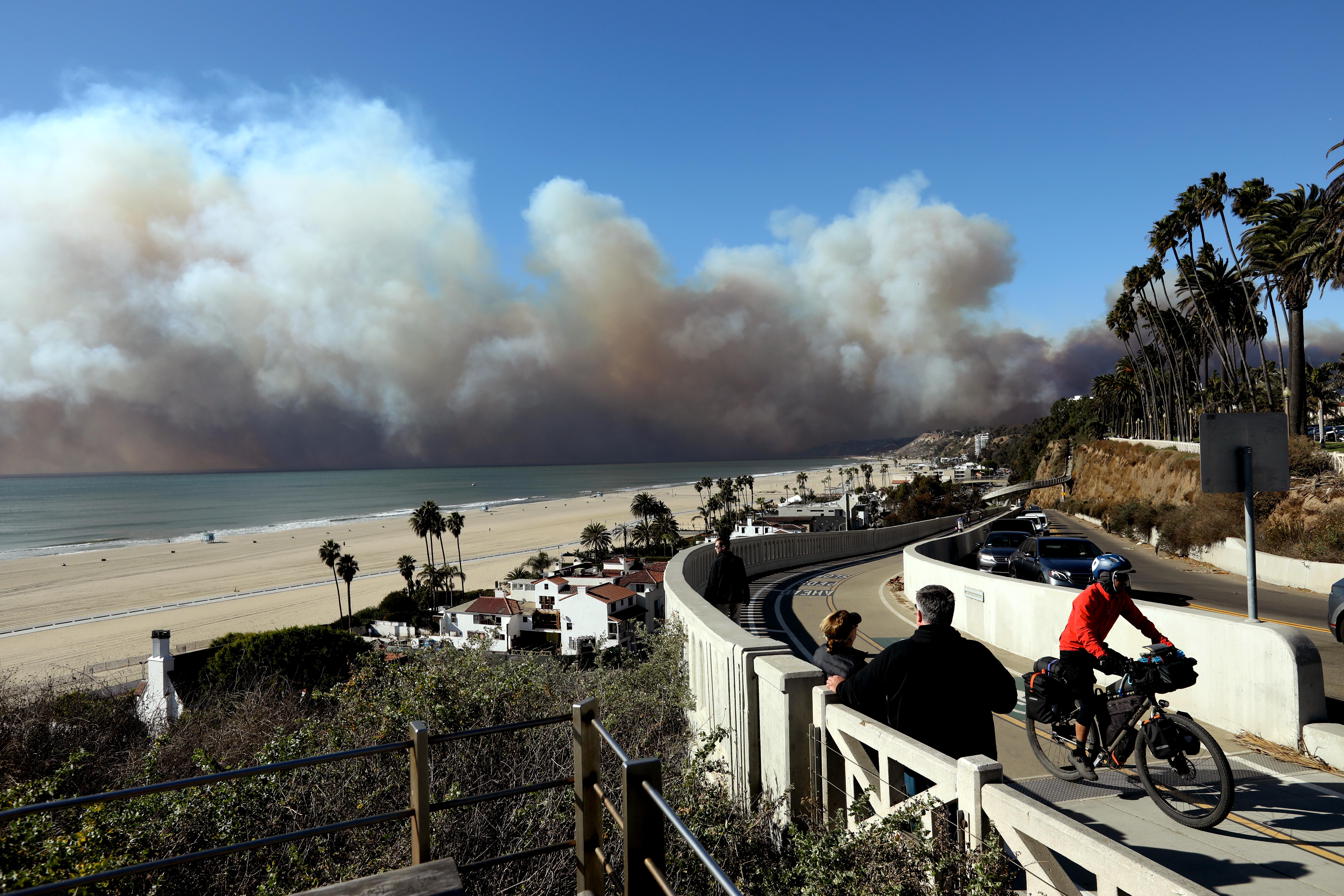 People watch the Palisades fire from the California Incline in Santa Monica on Jan. 7, 2025.