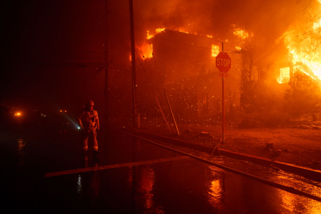 Firefighters battle flames from the Palisades Fire on Jan. 7, 2025 in the Pacific Palisades.