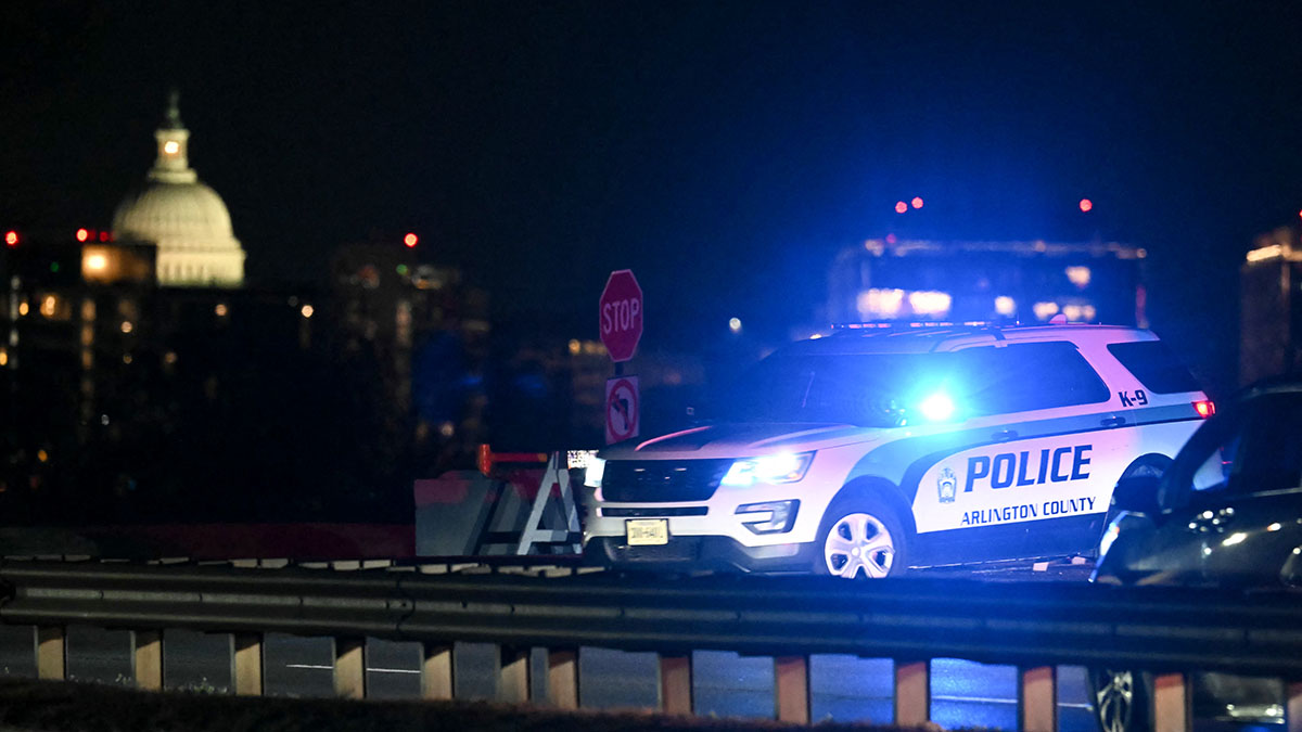 The U.S. Capitol is seen in the distance as a police vehicle blocks the entrance to the Potomac River near Reagan National Airport after a regional jet from Kansas crashed into after colliding mid-air with a military helicopter near Reagan National Airport. (Photo by ANDREW CABALLERO-REYNOLDS/AFP via Getty Images)
