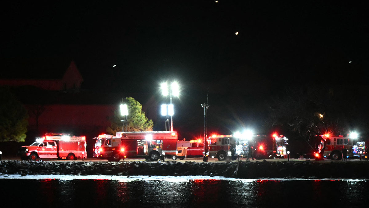 Emergency vehicles and rescue crews gather along the Potomac River near Reagan National Airport after an air crash near Washington, D.C., on Jan. 29, 2025. A regional jet from Kansas crashed into Washington’s Potomac River after colliding mid-air with a military helicopter near Reagan National Airport, officials said Wednesday, prompting a major emergency response and grounding all flights. (Photo by ANDREW CABALLERO-REYNOLDS/AFP via Getty Images)