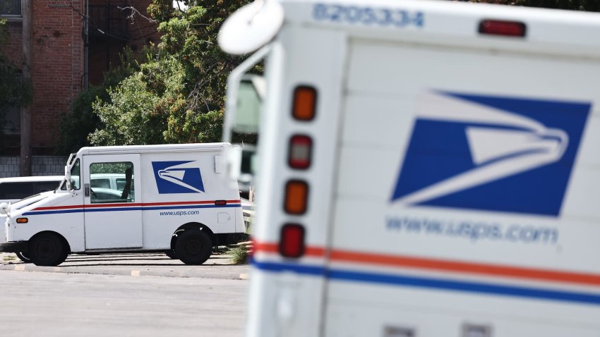 U.S. Postal Service (USPS) trucks are parked at a post office on August 23, 2024 in Los Angeles, California.