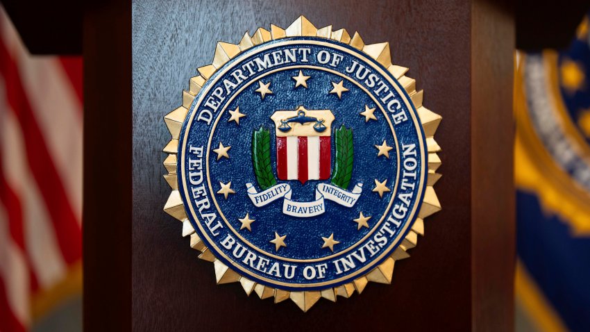 An FBI seal is displayed on a podium