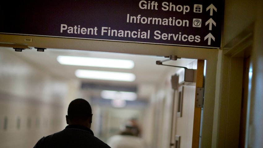 A sign points visitors toward the financial services department at a hospital,