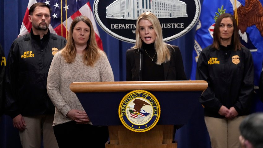 Attorney General Pam Bondi speaks at a news conference regarding immigration enforcement at the Justice Department, Wednesday, Feb. 12, 2025, in Washington, as Tammy Nobles, second from left, mother of Kayla Hamilton listens.