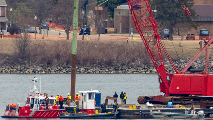 ARLINGTON, VIRGINIA – FEBRUARY 02: A crane moves in to place on the Potomac River for recovery efforts on February 02, 2025 in Arlington, Virginia. An American Airlines flight from Wichita, Kansas collided midair with a military Black Hawk helicopter while on approach to Ronald Reagan Washington National Airport on January 29, 2025 outside of Washington, DC. According to reports, there were no survivors among the 67 people onboard both aircraft. (Photo by Tasos Katopodis/Getty Images)