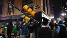 Philadelphia Eagles fans celebrate in the streets, destroying property and taking down traffic signals in downtown Philadelphia following the victory of Philadelphia Eagles in Super Bowl LIX over the Kansas City Chiefs in Philadelphia, Pennsylvania, United States on February 10, 2025. (Photo by Kyle Mazza/Anadolu via Getty Images)