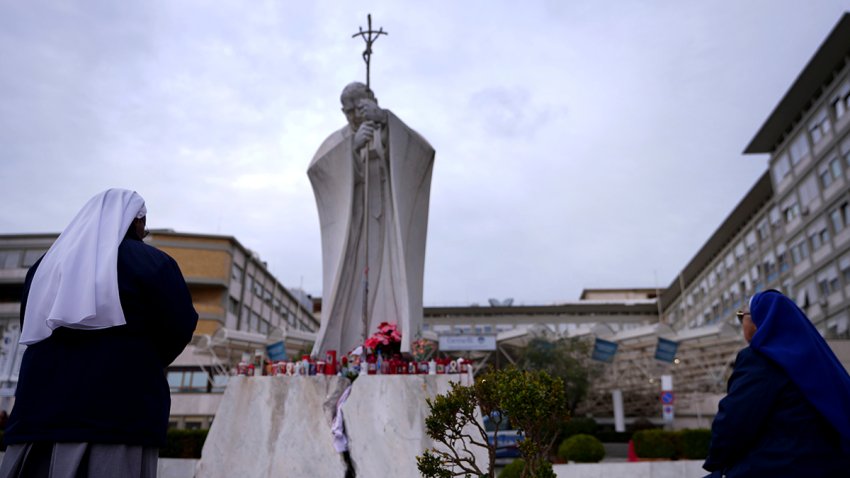 People pray for Pope Francis in front of the Agostino Gemelli Polyclinic, where the Pontiff has been hospitalized since Feb. 14, in Rome, Wednesday, Feb. 26, 2025.