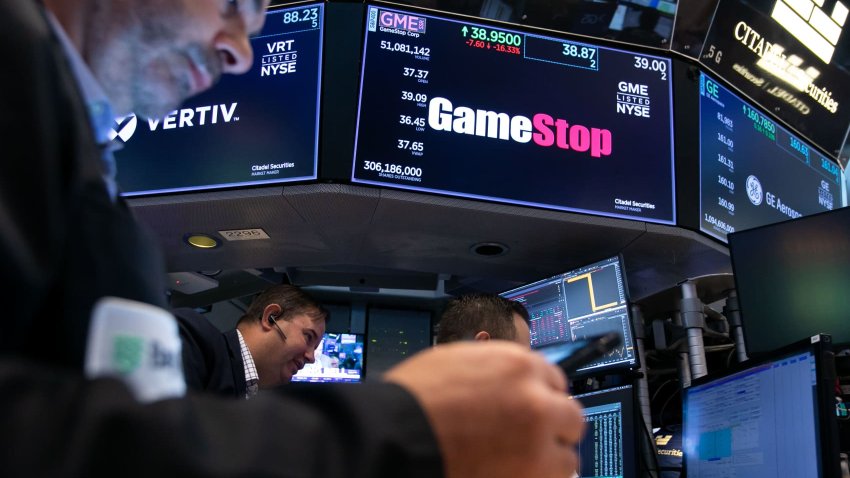 Traders work underneath GameStop Corp. signage on the floor of the New York Stock Exchange (NYSE) in New York, US, on Friday, June 7, 2024. 