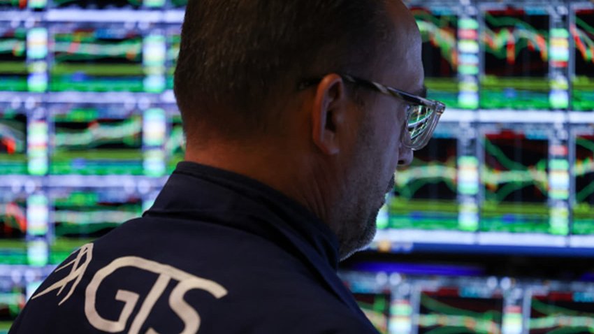 Traders work on the floor of the New York Stock Exchange at the opening bell on March 7, 2025.