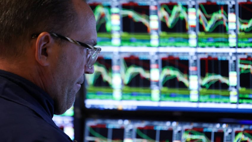 A trader works on the floor of the New York Stock Exchange at the opening bell on March 10, 2025.