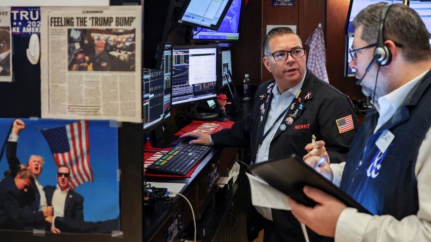 Traders work on the floor at the New York Stock Exchange on March 24, 2025.