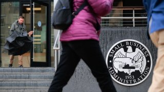 People walk past the headquarters of the U.S. Small Business Administration in the Southwest Federal Center area on March 24, 2025 in Washington, DC.