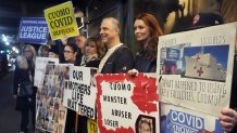 Demonstrators, including Lindsey Boylan, second from right, a former aide to former Gov. Andrew Cuomo, who accused him of an unwanted kiss, stand outside a fundraiser in New York, Tuesday, March 4, 2025. (AP Photo/Richard Drew)