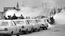 FILE - Clouds of tear gas fill the air as state troopers, ordered by Gov. George Wallace, break up a demonstration march in Selma, Ala., March 7, 1965, on what became known as 