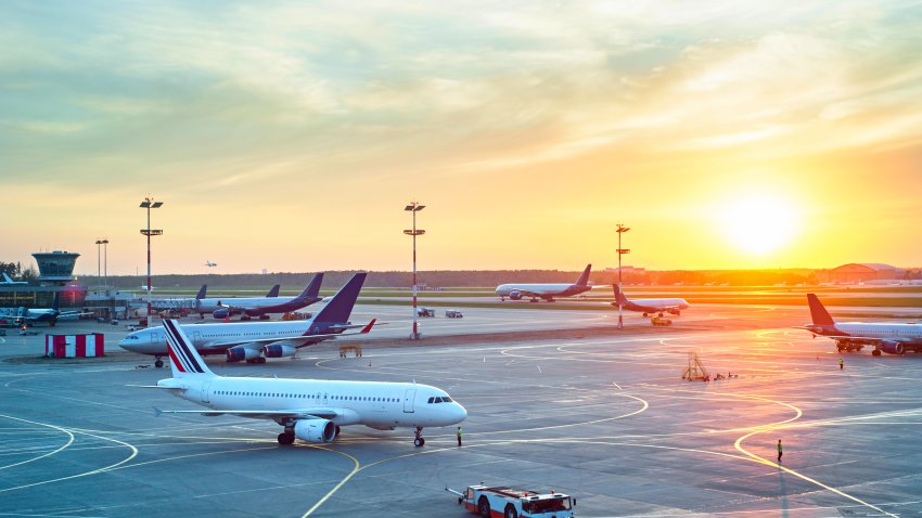 Airport with many airplanes at beautiful sunset