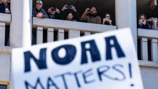 UNITED STATES &#8211; MARCH 3: National Oceanic and Atmospheric Administration workers watch a rally outside headquarters to oppose the recent firings, in Sliver Spring, Md., on Monday, March 3, 2025. Sen. Chris Van Hollen, D-Md., and other members of Congress also attended.