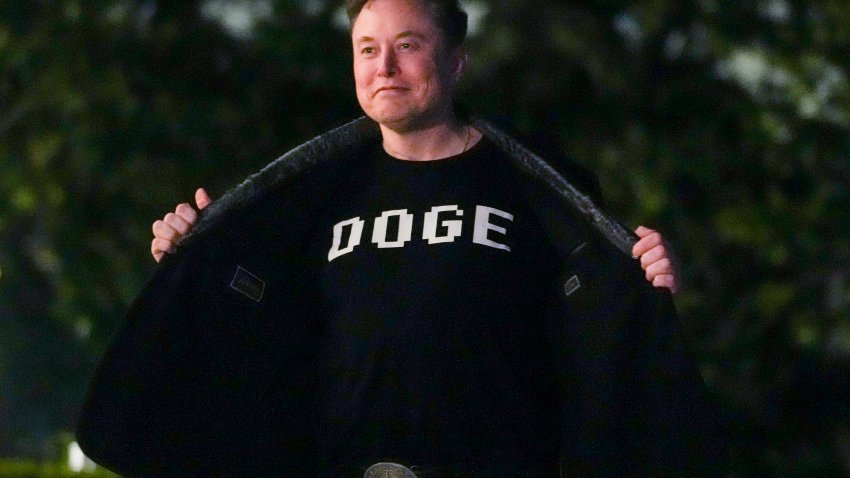 Elon Musk shows off a shirt that says "DOGE"