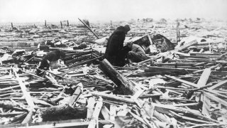 Inhabitants comb the wreckage of the town of Griffin, Indiana, in the wake of the tri-state tornado, March 1925. The tornado began in Missouri on the 18th March, and tore through Illinois and Indiana, killing 689 people. (Photo by Topical Press Agency/Hulton Archive/Getty Images)