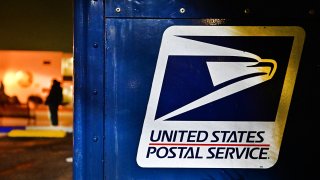 The United State Postal Service emblem is seen on the side of a mailbox on Feb. 4, 2025.