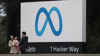 Visitors take pictures by a sign posted in front of Meta headquarters in Menlo Park, California, on Jan. 29, 2025.