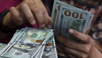 A teller counts U.S. dollar bank notes at a money changer in Jakarta, Indonesia, on April 9, 2025.
