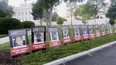 White House driveway lined with posters of migrants WH says were arrested