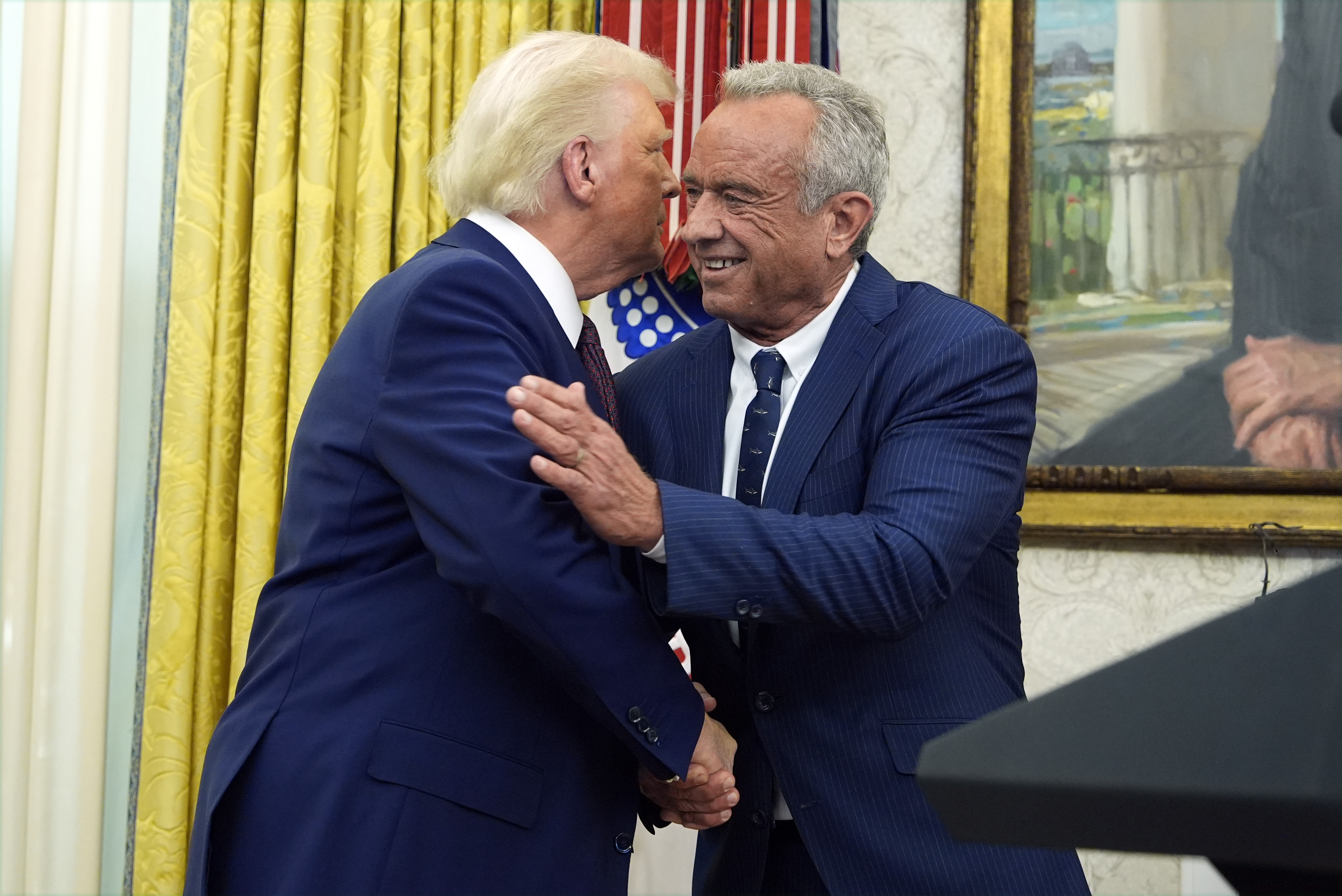 President Donald Trump congratulates Robert F. Kennedy Jr., after he was sworn in as Health and Human Services Secretary in the Oval Office at the White House, Thursday, Feb. 13, 2025, in Washington.