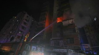A firefighter extinguishes the flames inside an apartment that was hit by an apparent Israeli airstrike, in the southern port city of Sidon, Lebanon, early Friday, April 4, 2025.