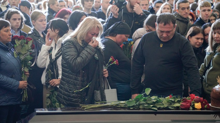 KYIV, UKRAINE – APRIL 28: Relatives and friends attend the farewell ceremony for 17-year-old Danylo Khudei and his parents, father Oleh and mother Viktoriia, who were killed during a Russian missile strike on April 28, 2025 in Kyiv, Ukraine. A farewell ceremony was held at Baikove Cemetery for 17-year-old Danylo Khudei and his parents — father Oleh and mother Viktoriia — who were killed in the Russian missile strike on the Sviatoshynskyi district during the night of April 24.