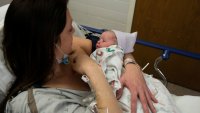 Amanda Dodd holds her newborn child, Madeline, after giving birth in the Family Birth Center at Beaumont Hospital in Royal Oak, Michigan, U.S., February 1, 2022.
