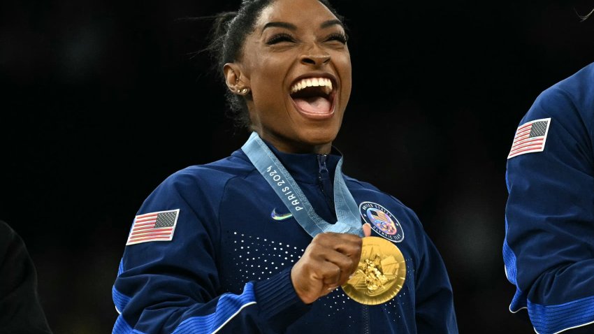 Simone Biles poses with the gold medal during the podium ceremony at the 2024 Paris Olympic Games at the Bercy Arena in Paris on July 30, 2024.