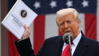 U.S. President Donald Trump holds a document as he delivers remarks on tariffs in the Rose Garden at the White House in Washington, D.C., on April 2, 2025.