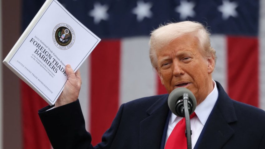 U.S. President Donald Trump holds a document as he delivers remarks on tariffs in the Rose Garden at the White House in Washington, D.C., on April 2, 2025.