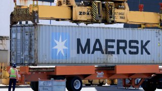 Shipping containers are offloaded from a cargo ship at PortMiami on April 15, 2025 in Miami.
