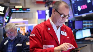 Traders work on the floor of the New York Stock Exchange during morning trading on April 30, 2025 in New York City.