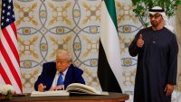 U.S. President Donald Trump signs a guest book next to United Arab Emirates President Sheikh Mohamed bin Zayed Al Nahyan, at Qasr Al Watan, in Abu Dhabi, United Arab Emirates, May 15, 2025.