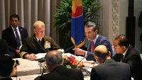 US Secretary of Defense Pete Hegseth (C) gestures beside Malaysia’s Defence Minister Mohamed Khaled Nordin (R) and other defence officials from the Association of Southeast Asian Nations (ASEAN) during a multilateral meeting ahead of the Shangri-La Dialogue Summit in Singapore on May 30, 2025.