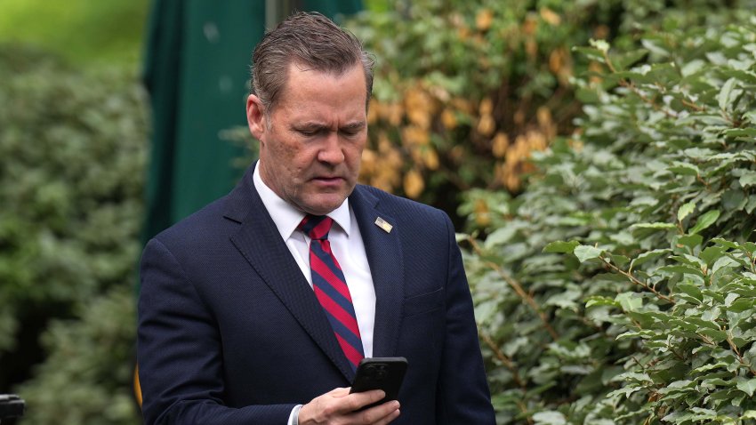National Security Advisor Michael Waltz looks at his phone