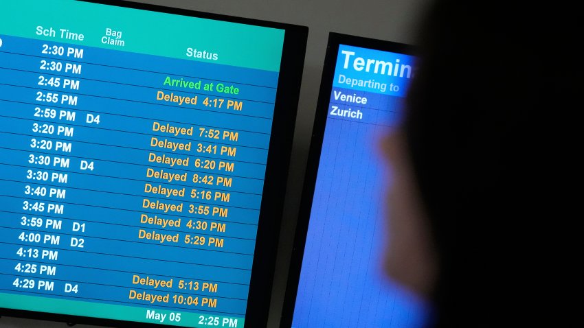 A display shows the status of flights at Newark Liberty International Airport in Newark, N.J., Monday, May 5, 2025.