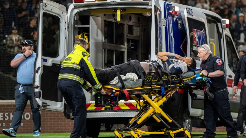 New York Yankees’ Oswaldo Cabrera is taken from the field by ambulance after injuring his leg while scoring a run during the ninth inning of a baseball game against the Seattle Mariners, Monday, May 12, 2025, in Seattle. (AP Photo/Stephen Brashear)
