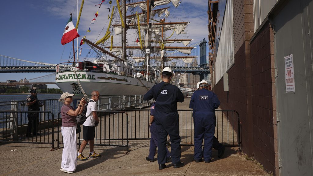 United States Coast Guardsmen arrive at Pier 35, Sunday, May 18, 2025 in New York, where the Cuauhtémoc, a masted Mexican Navy training ship that collided with the Brooklyn Bridge the night before, sits docked. (AP Photo/Yuki Iwamura)