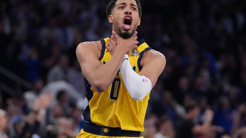 Indiana Pacers guard Tyrese Haliburton (0) makes a choke motion towards the New York Knicks after hitting a shot at the end of the fourth quarter of Game 1 of the NBA basketball Eastern Conference final, Wednesday, May 21, 2025, in New York.