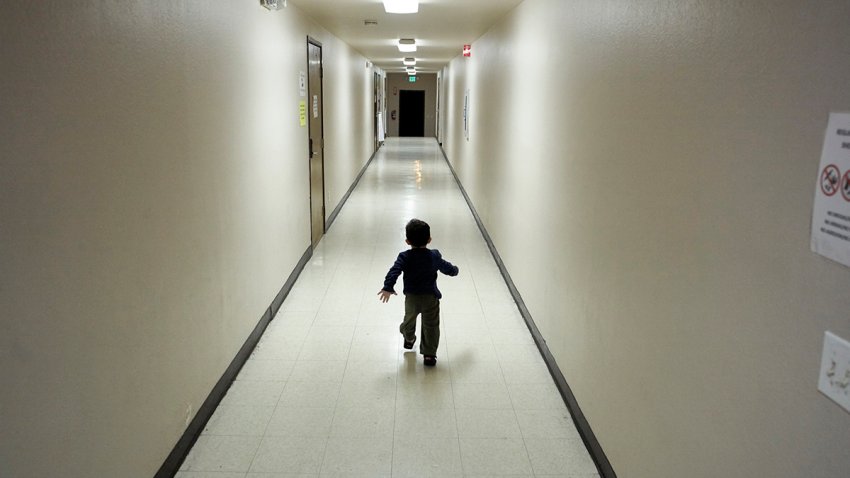 FILE - An asylum-seeking boy from Central America runs down a hallway after arriving from an immigration detention center to a shelter in San Diego, Dec. 11, 2018.