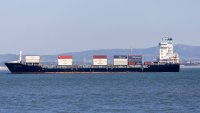 A cargo ship loaded with containers sails near the coast of Portugal on May 24, 2025.
