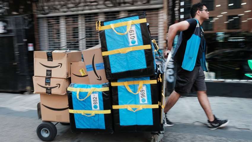 An Amazon worker moves boxes on Amazon Prime Day in the East Village of New York City, July 11, 2023.