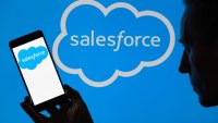 The Salesforce logo is being displayed on a smartphone, with Salesforce in the background, in this photo illustration in Brussels, Belgium, on June 16, 2024. 