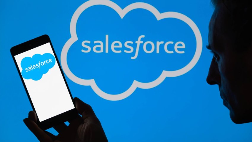 The Salesforce logo is being displayed on a smartphone, with Salesforce in the background, in this photo illustration in Brussels, Belgium, on June 16, 2024. 
