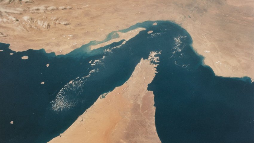 View looking north showing the Strait of Hormuz, connecting the Gulf of Oman with the Persian Gulf, with the Zagros Mountains and Qeshm Island of Iran in the background, and areas of Oman, Muscat and the United Arab Emirates in the foreground, as seen from the Space Shuttle Columbia during shuttle mission STS-52, 22nd October to 1st November 1992.
